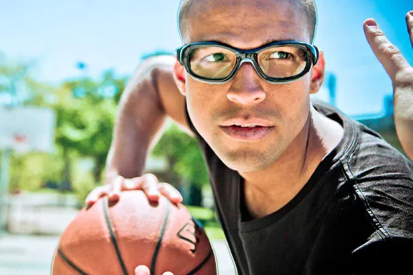 Boy playing basketball wearing glasses